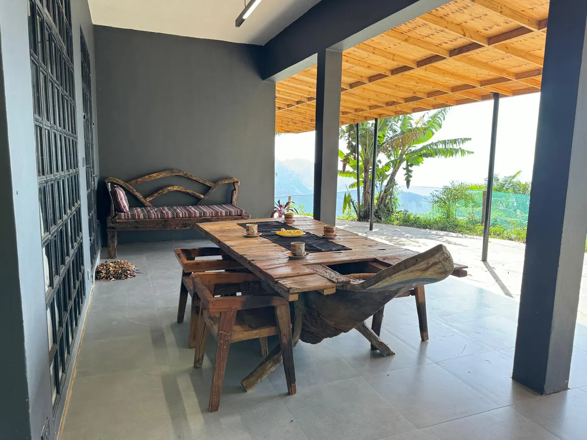 Main house living room with handmade dhow-wood furniture, Nilo Forest Lodge